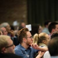 Faculty, staff, students, and community members listen to the panelists presentations.